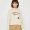 Calvin Klein Jeans Curved Stacked Logo Hoodie - Sweatshirt - Classic Beige -Gant shop c141db005fc04acfb3a1bd70592f1502